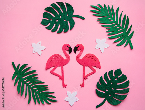 Flamingos and leaves on a pink background. Summer design.