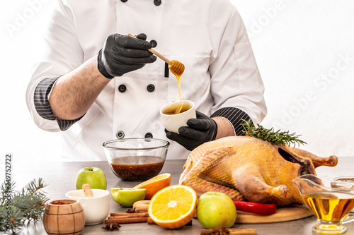 Cooking sweet and sour sauce for roast duck of a chef hands. on kitchen table white background. copy text