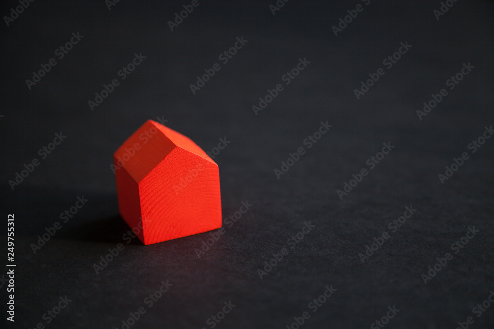 Small cute red wooden house on dark background