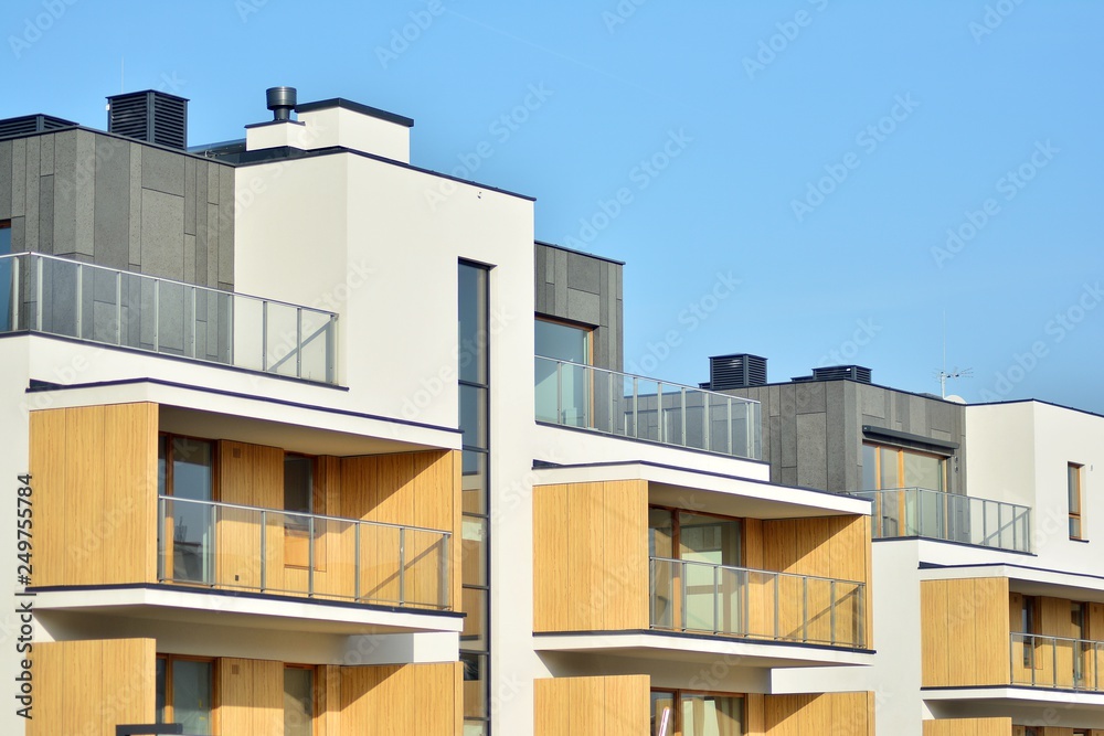 Modern apartment buildings on a sunny day with a blue sky. Facade of a modern apartment building Modern apartment buildings on a sunny day with a blue sky. Facade of a modern apartment building
