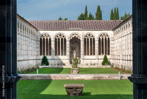 Courtyard with grass at the 13th century Camposanto Monumentale, ancient cemetery of Tuscany. Historic Piazza dei Miracoli is a UNESCO World Heritage Site, Italy photo