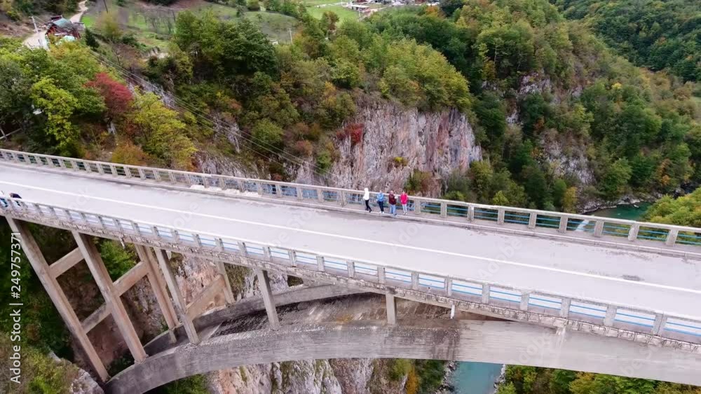Dzhurdzhevich Bridge. Drone flies around standing on the bridge of people.Canyon of the river Montenegro with a bird's-eye Dzhurdzhevich Bridge. Drone flies around standing on the bridge of people.Canyon of the river Montenegro with a bird's-eye