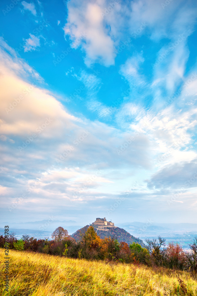 Fototapeta premium Clouds at the sunset on the Deva citadel