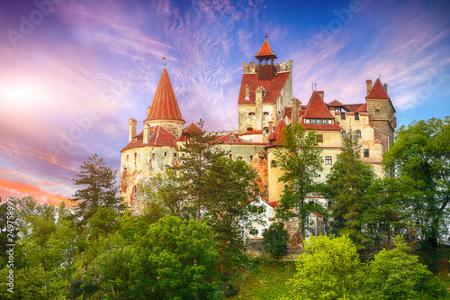 Landscape with medieval Bran castle known for the myth of Dracula at sunset photo