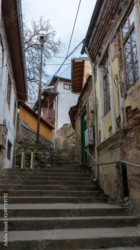 narrow old pedestrian street of Veliko Tarnovo in Bulgaria with old houses and stairs © Baifoworld