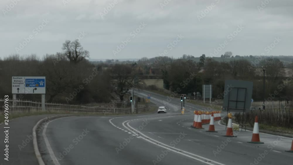 Road junction with light traffic under grey sky. Road junction with light traffic under grey sky.