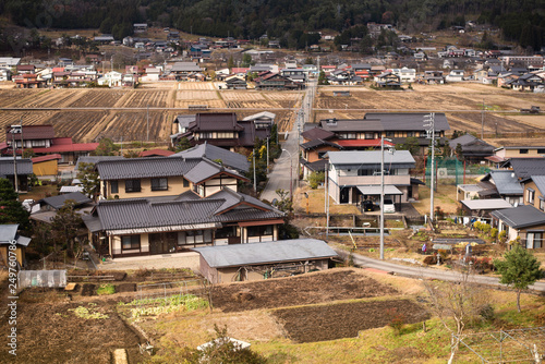 A small village in the valley on the way to Takayama in Japan. This view looks through the train window.