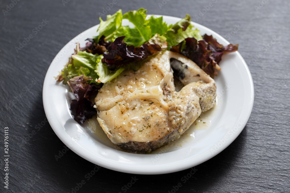 boiled fish with sauce and green salad on white plate boiled fish with sauce and green salad on white plate