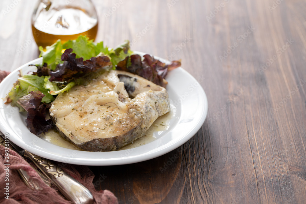 boiled fish with sauce and green salad on white plate boiled fish with sauce and green salad on white plate
