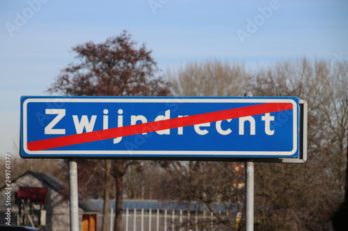 Red white sign with red line that indicates the end of the urban area of the city of Zwijndrecht in the Netherlands