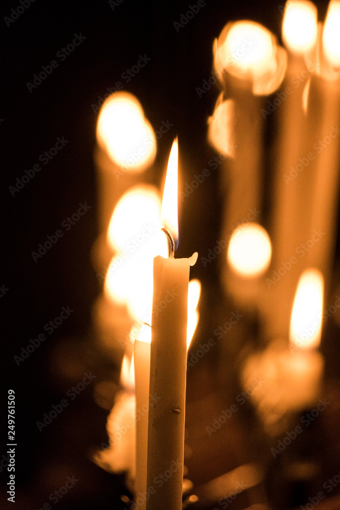 candela accesa in una chiesa Stock Photo | Adobe Stock