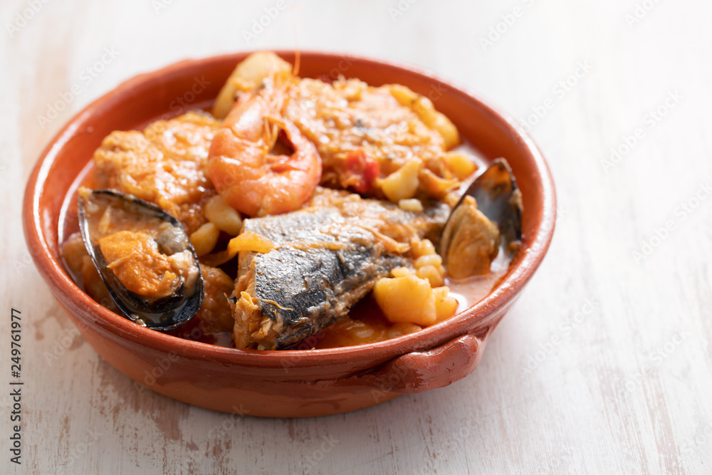 portuguese fish and seafood stew in dish on ceramic background portuguese fish and seafood stew in dish on ceramic background