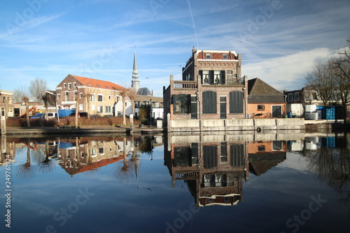 old museum harbor of Gouda with historic ships at mallegatsluis sluice to the Hollandsche IJssel in the Netherlands photo