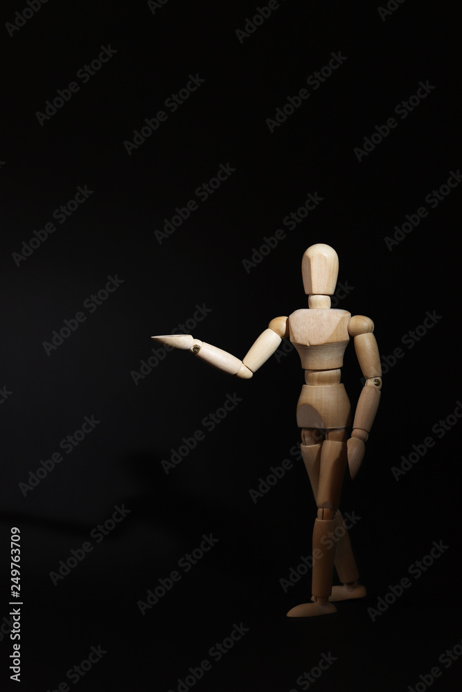 A wooden mannequin shows with his hand. The concept of pointing at someone with your finger. The mannequin will stretch out his hand. Wooden man concept. Wooden mannequin A wooden mannequin shows with his hand. The concept of pointing at someone with your finger. The mannequin will stretch out his hand. Wooden man concept. Wooden mannequin