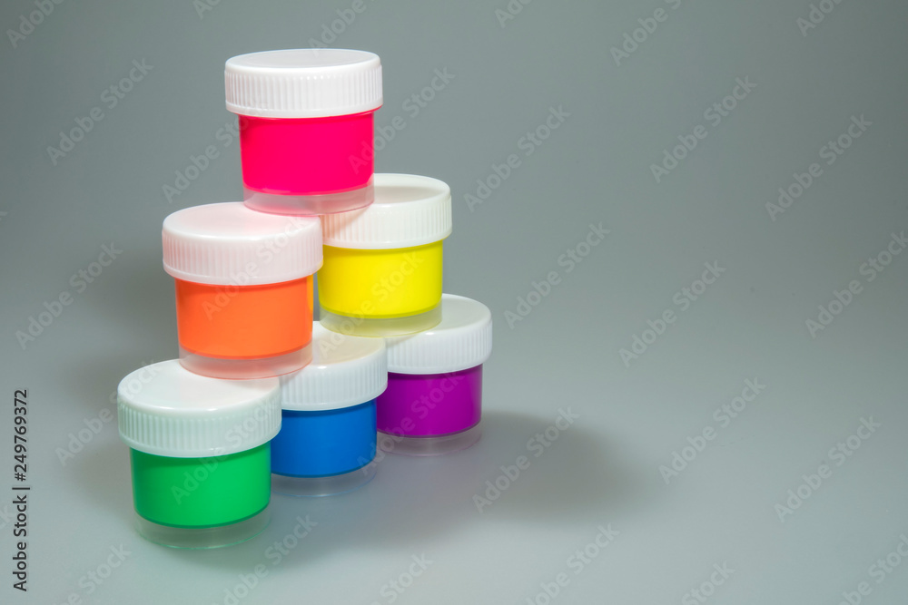 Acrylic paint jars stacked in a pyramid Acrylic paint jars stacked in a pyramid
