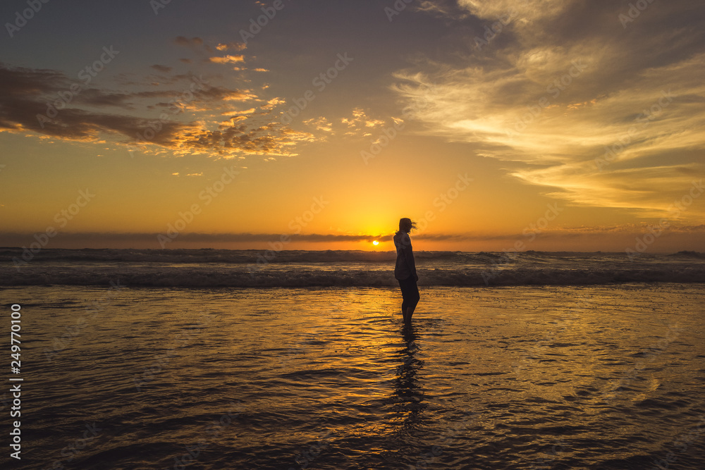 Fototapeta premium carefree woman dancing in the sunset on the beach. vacation vitality healthy living concept, Australia