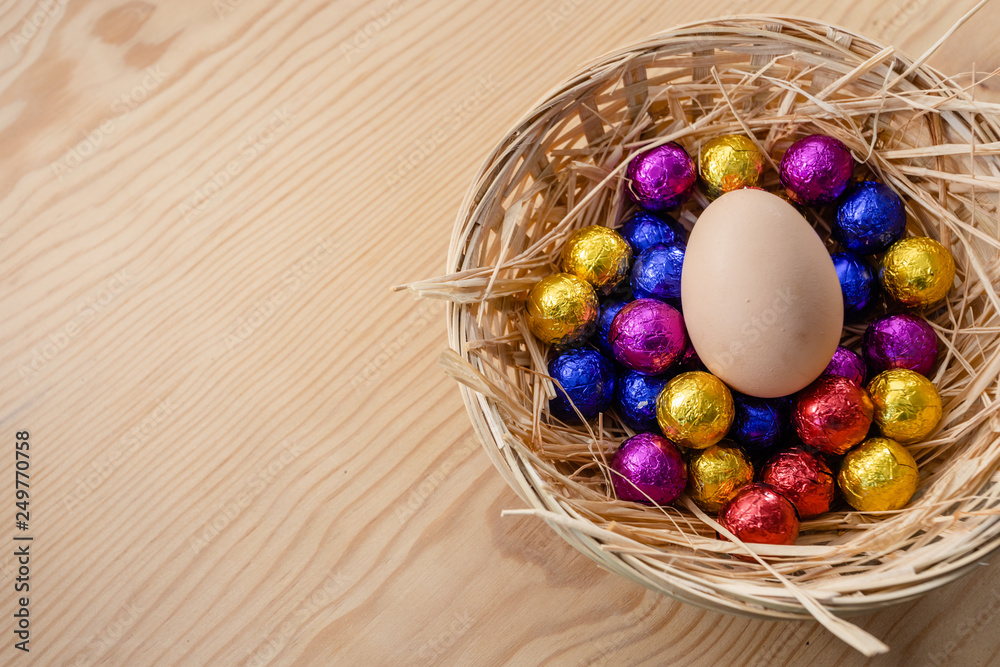 colorful easter eggs in a basket on wooden background. colorful easter eggs in a basket on wooden background.