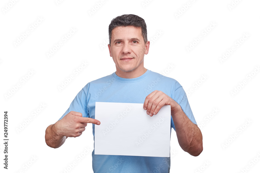 senior man with smiling face holding blank paper and making a gesture pointing his finger at him. senior man with smiling face holding blank paper and making a gesture pointing his finger at him.