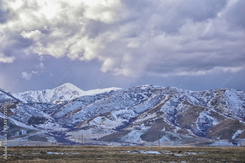 inter Panorama of Oquirrh Mountain range snow capped, which includes The Bingham Canyon Mine or Kennecott Copper Mine, rumored the largest open pit copper mine in the world in Salt Lake Valley, Utah. 