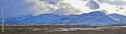 inter Panorama of Oquirrh Mountain range snow capped, which includes The Bingham Canyon Mine or Kennecott Copper Mine, rumored the largest open pit copper mine in the world in Salt Lake Valley, Utah.  photo