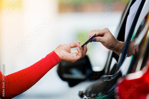 Selective focus to woman driver pay credit card