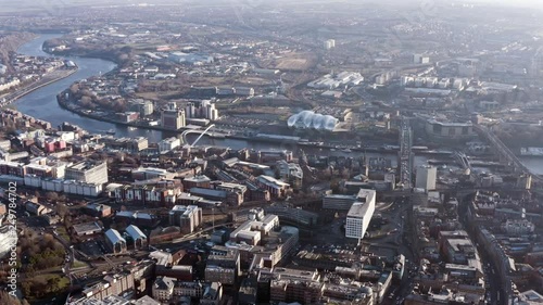 Newcastle upon Tyne aerial view is a university city on the River Tyne in northeast England flying over famous Spanning the Tyne, modern iconic landmark Gateshead Millennium Bridge in the UK - HD 4K  photo