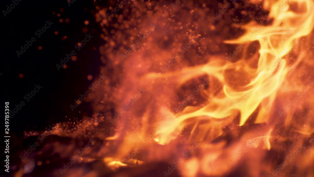 SLOW MOTION, MACRO, DOF: Bright sparkles flying out of a orange campfire burning in the pitch dark. Cinematic shot of orange flames engulfing coals in a campfire and sparks popping up into the air. SLOW MOTION, MACRO, DOF: Bright sparkles flying out of a orange campfire burning in the pitch dark. Cinematic shot of orange flames engulfing coals in a campfire and sparks popping up into the air.