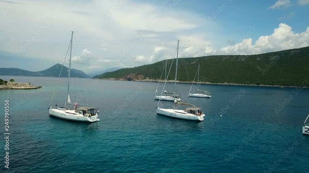 Aerial top view of a sailing yacht regatta near the island. Flying over boats. Aerial top view of a sailing yacht regatta near the island. Flying over boats.