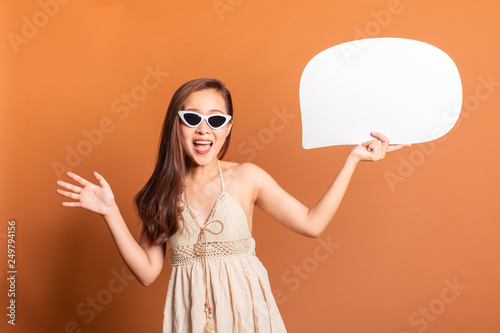 Young Asian woman in summer swimming suit smile happy over orange background with copy space