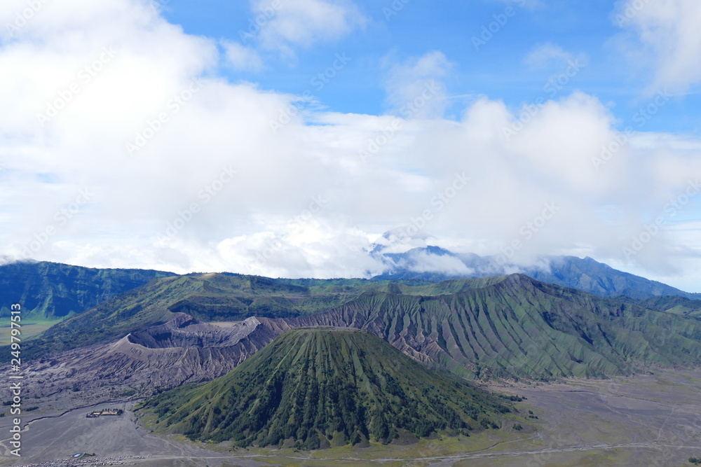 Fototapeta premium The delightful volcanic complex Bromo Tengger Semeru National Park against the background of fascinating views of nature, sky, craters and clouds