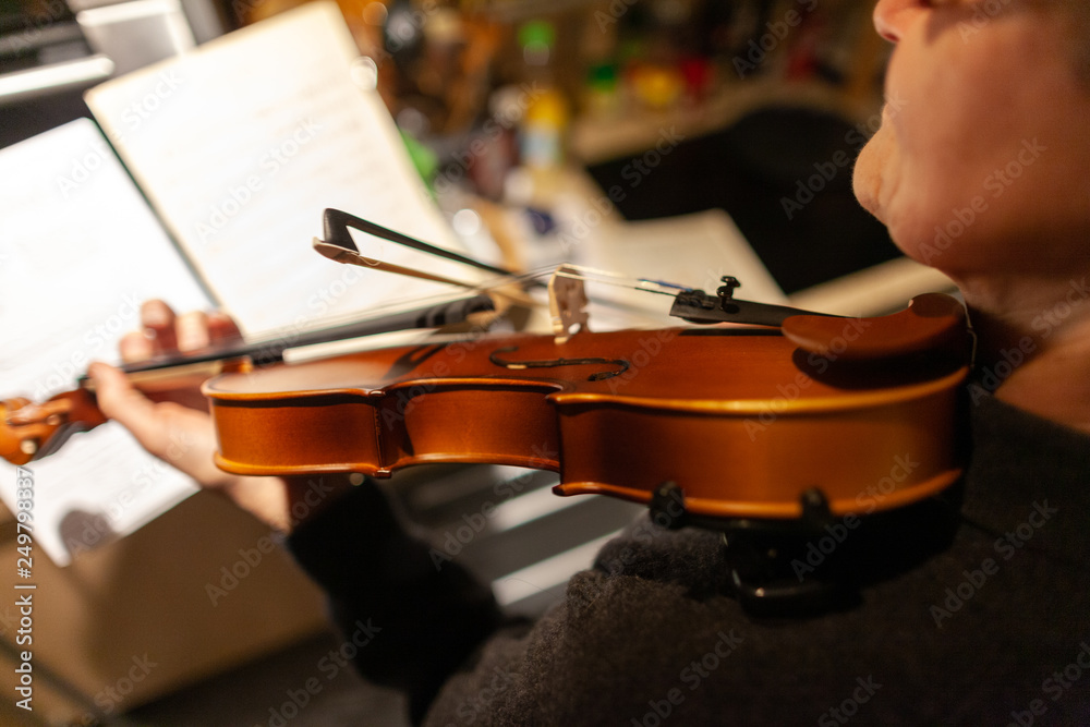 Fototapeta premium A woman plays a violin in a room