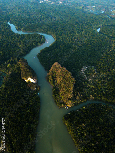 Image from drone of river in Krabi town, Thailand. Green trees, mountains and rocks around river. © dimabucci
