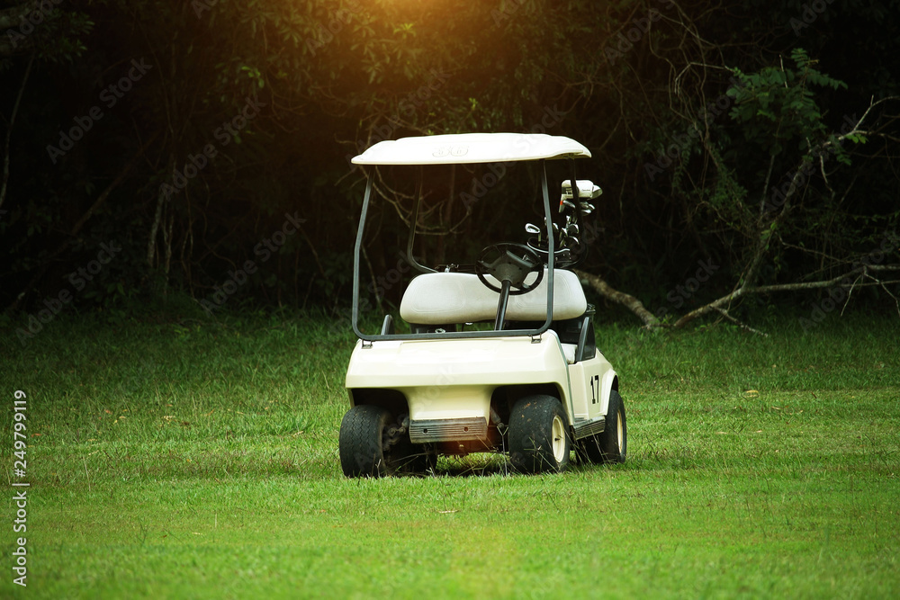 Golfcar in beautiful golf course in the evening golf course with sunshine