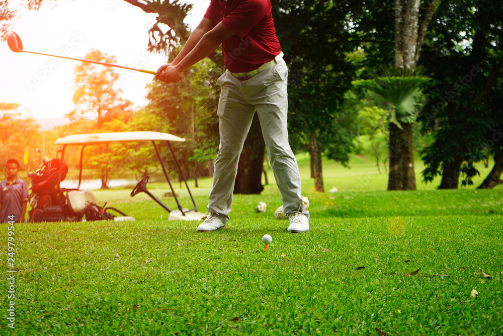 Golfer playing golf beside the golfcar in beautiful golf course in the evening golf course with sunshine in thailand