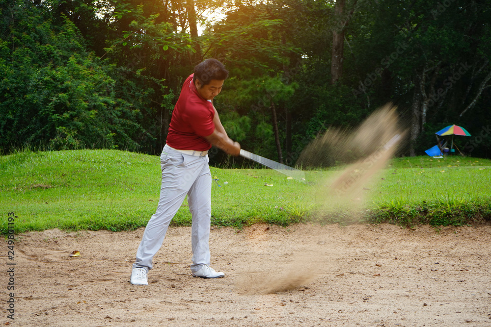 Blurred golfer playing golf in beautiful golf course in the evening golf course with sunshine in thailand Blurred golfer playing golf in beautiful golf course in the evening golf course with sunshine in thailand