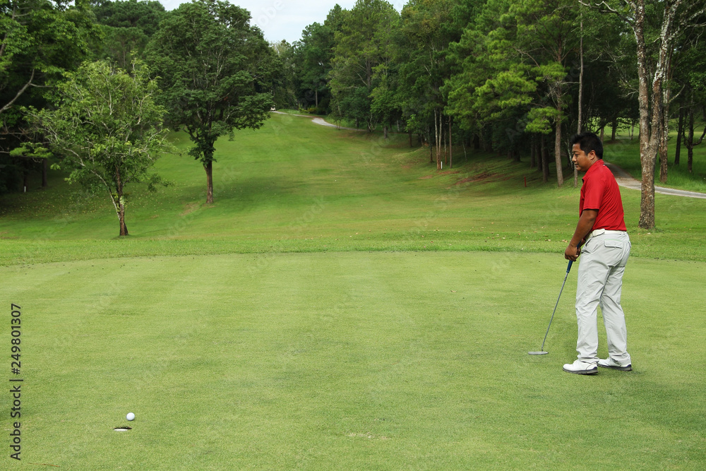 Golfers are putting golf in the evening golf course golf backglound in Thailand Golfers are putting golf in the evening golf course golf backglound in Thailand