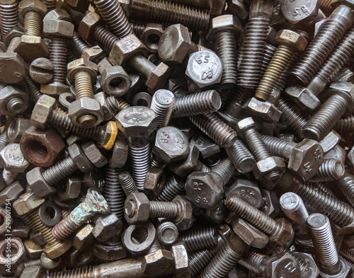 Many small and large bolts, nuts. rusty and dirty. view from above © Степан Хаджи