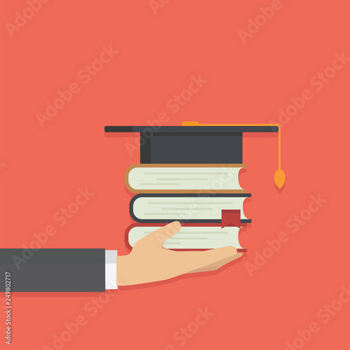 Hand holding stack of book with graduates hat, graduation or scholarship concept