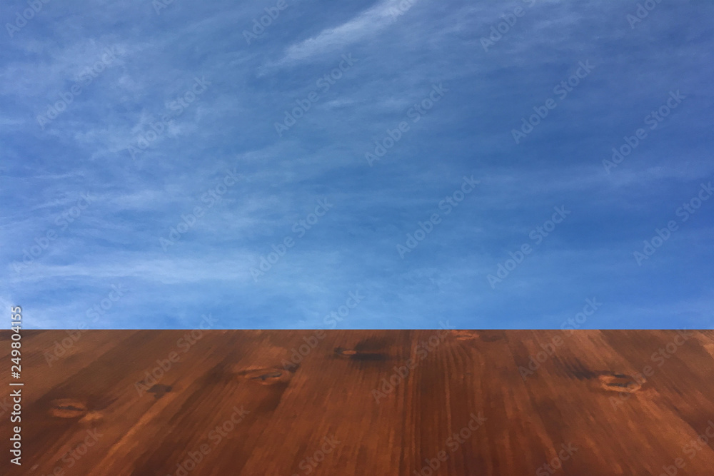 old brown oak wooden table on the blurry blue sky clouds background, wood table