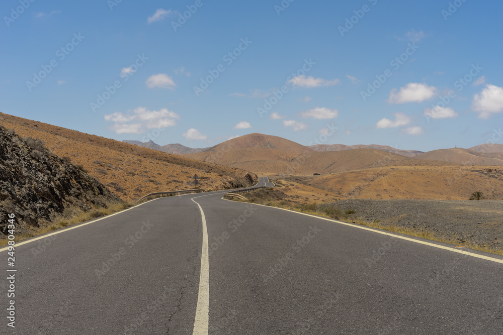 Road in the mountains, on a Canarian island, Fuerteventura with blue sky