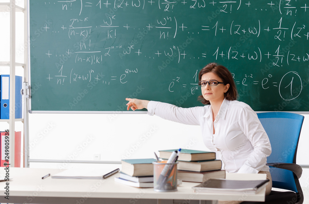 Female math teacher in front of the chalkboard 