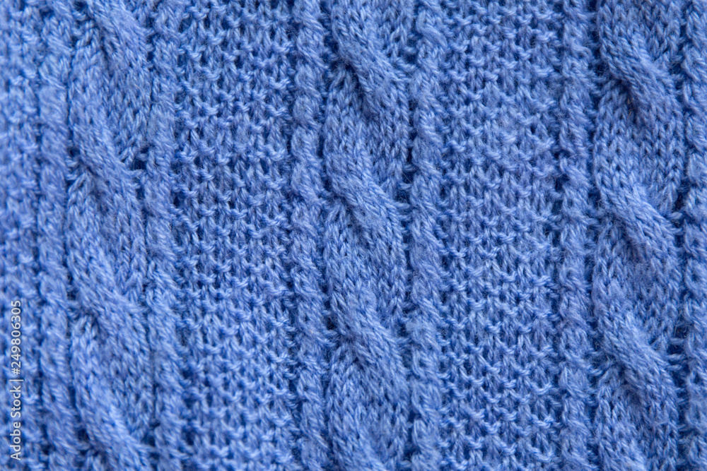 Blue knitted wool fabric texture. Cozy warm winter background.
