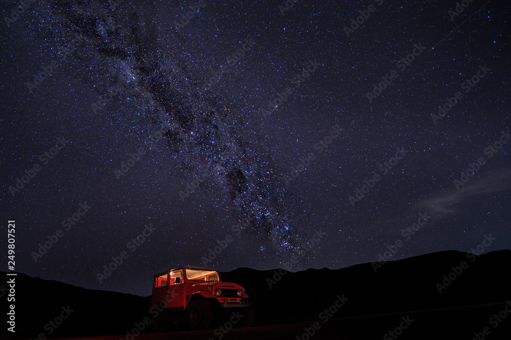 Milky way with red car at Mt.Bromo,East Java,Indonesia. The image may contains noise due to long exposure photography.