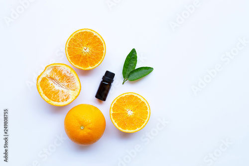 Orange essential oil on white background.