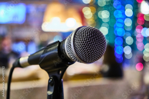 microphone on a stand up comedy stage with colorful bokeh , high contrast image