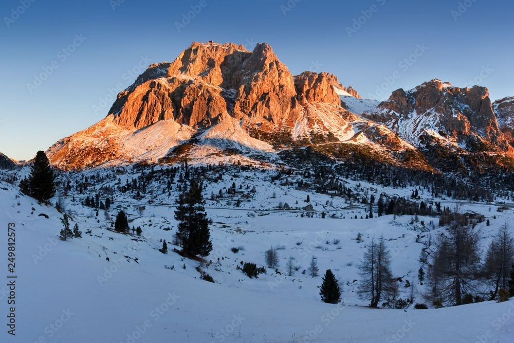 Mountain landscape panoramic view with blue sky 
Gorgeous winter sunset in Dolomites, Italy. Colorful outdoor scene, Happy New Year celebration concept. Panorama of white winter mountains with snow