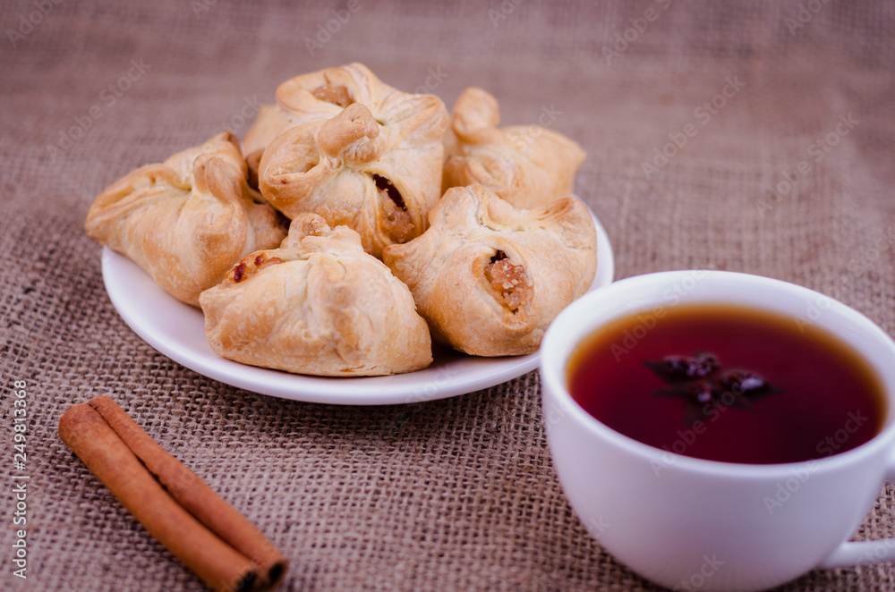 Apple patties on a background of burlap with coffee and cinnamon stick Apple patties on a background of burlap with coffee and cinnamon stick
