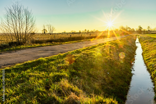 colorful winter sunrise on a field in recker moor photo