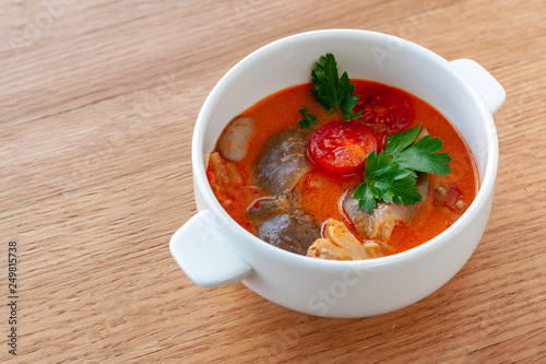 Vegetarian soup Tom Yam with coconut milk, mushrooms and cherry tomatoes.