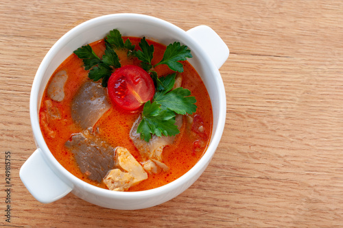 Vegetarian soup Tom Yam with coconut milk, mushrooms and cherry tomatoes.